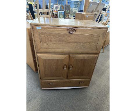 Ercol light elm bureau cabinet with drop down front over a drawer and cupboard base