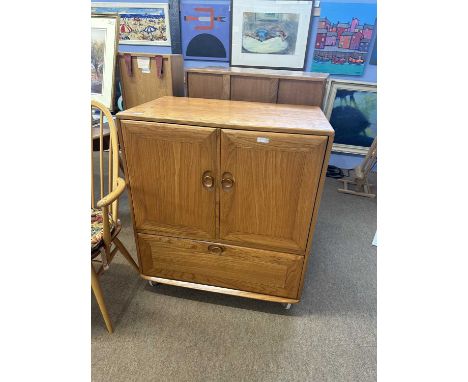 Ercol light elm television cabinet with two doors and drop down front, later internal modification, 85cm wide