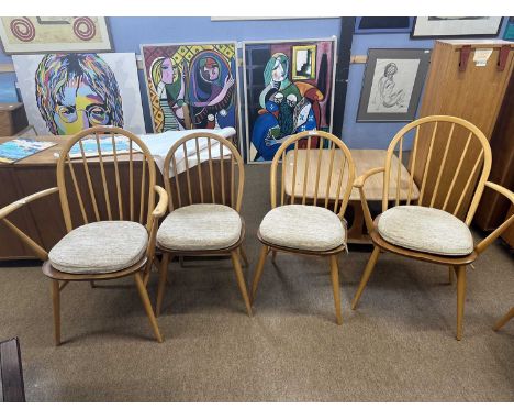 Set of four Ercol stick back dining chairs with oatmeal coloured seat pads