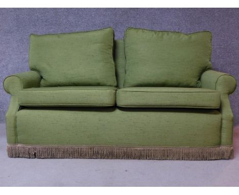 A contemporary green fabric two seater sofa, on casters. H.82 W.165 D.85cm 