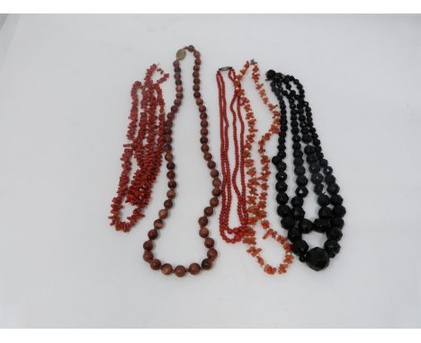 A collection of antique coral and gemstone necklaces. Including a Chinese goldstone necklace with gilt push clasp,  Pearl and