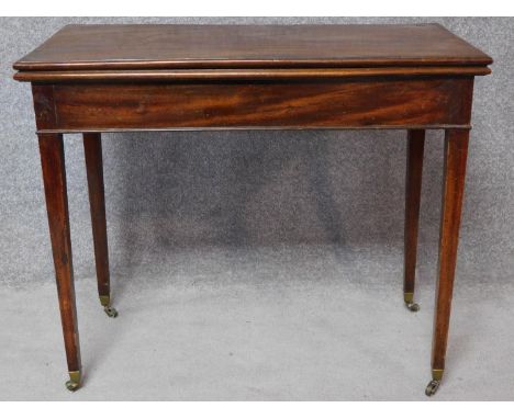 An Georgian mahogany foldover top card table raised on square tapering supports terminating in casters. H.73 W.88 D.89cm 