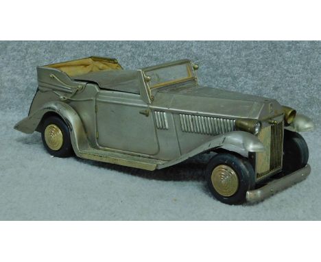 A vintage metal musical jewellery box in the form of a Rolls-Royce. It has three internal compartments. It plays If I were a 