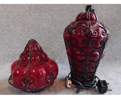 A pair of 1920's blown red glass lights, one table lamp with wirework design and one similar lampshade. H.37cm 