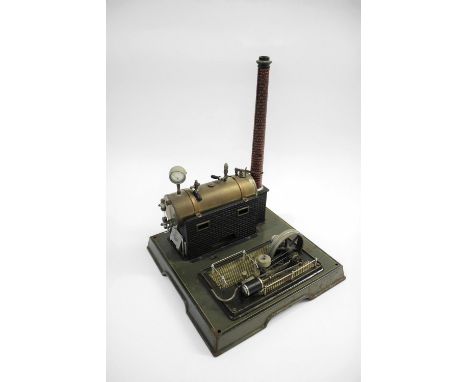 MARKLIN STEAM PLANT a brass and tin plate steam engine, with a single fly wheel, pressure gauge and chimney. Mounted on a met