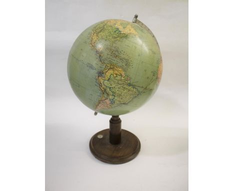 TERRESTRIAL GLOBE ON STAND a large terrestrial globe mounted on a wooden stand with inset compass, probably early 20thc. 53cm