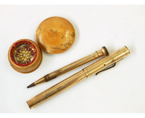 A 19th century gilt metal, pearl and bead keepsake in a turned boxwood case and gold filled fountain pen and propelling penci