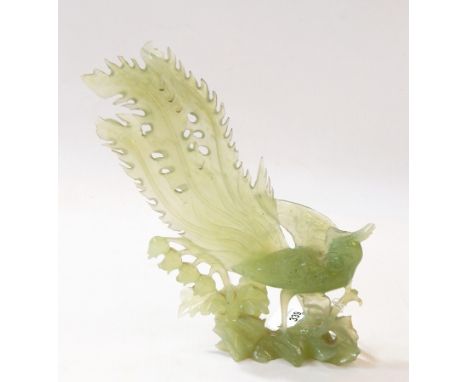 20th century carved jade model of a pheasant/peacock standing on rocky outcrop among foliage, 24cm high