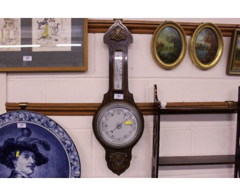 An oak cased aneroid barometer 