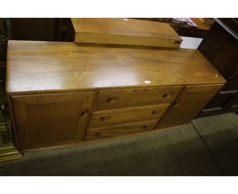 A light Ercol elm sideboard fitted three drawers 