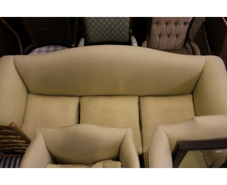 A mahogany and upholstered three seater sofa, raised on claw and ball supports 