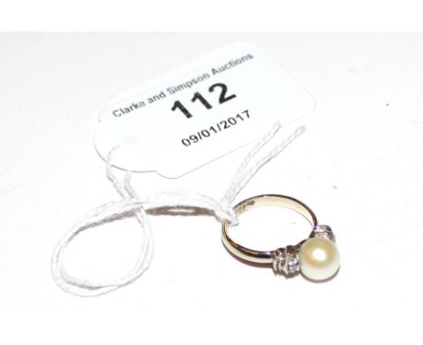 A white metal pearl and diamond set ring