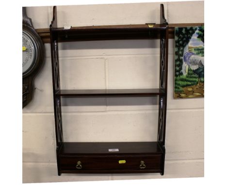 A mahogany three tier wall shelf fitted single drawer 