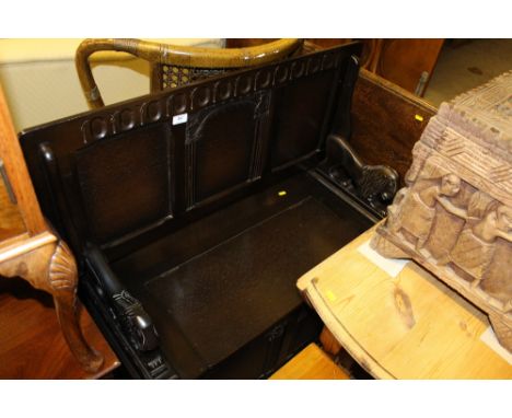 An oak paneled monks bench 