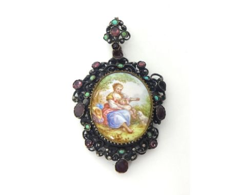 A late 19th century Austro-Hungarian metal pendant, the central porcelain portrait set within an openwork frame set with garn