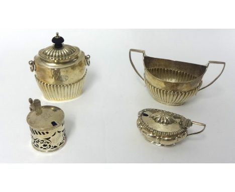 An Edwardian silver tea caddy, Birmingham 1902, of oval half fluted form, a Victorian silver sugar bowl, London 1888, of oval