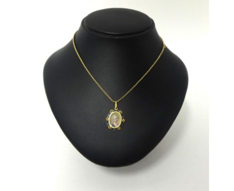 An 18ct gold and enamel portrait pendant, the classical lady within a  navy blue border, associated chain.