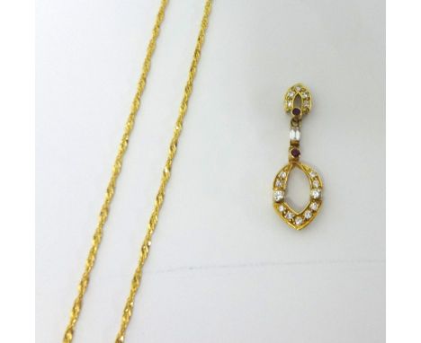 A ruby and diamond set openwork pendant, the oval drop set with brilliant cut diamonds, collet set rubies and diamonds above,