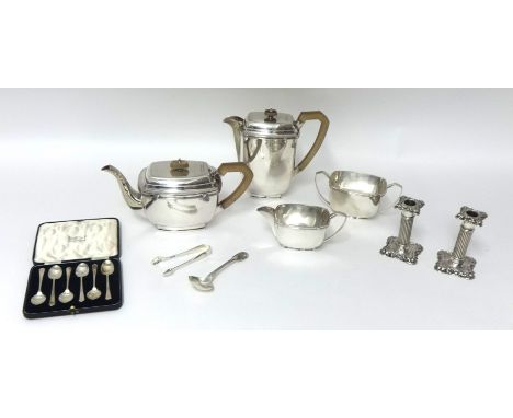 An electroplated four piece tea and coffee service, together with a pair of silver sugar tongs, a pair of silver candlesticks