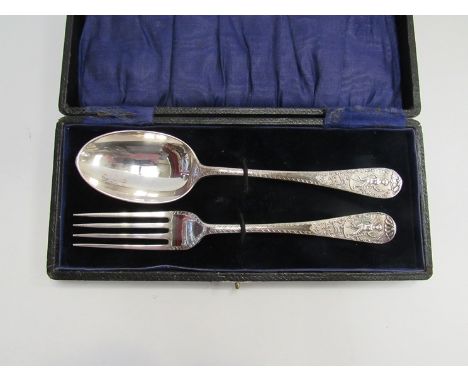 A cased silver fork and spoon with figural scenes 
