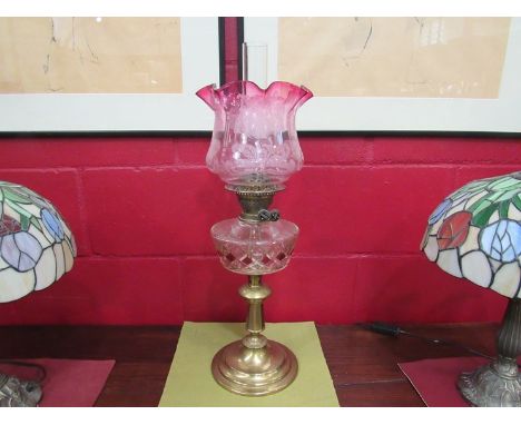 A brass based duplex oil lamp with etched floral shade, frilled rim 