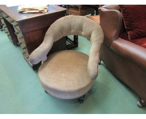 An ebonised late Victorian open armchair on turned fore legs and ceramic castors 