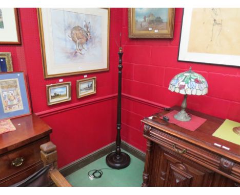 A mahogany standard lamp with melon fluted column 