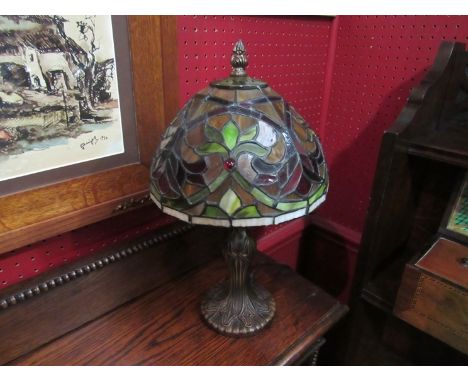 A Tiffany style lamp with leaded glass shade. 35cm tall (repair to base shade supports) 