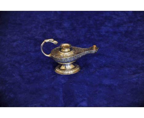 An Edward VII silver oil lamp with birds head form loop handle, the body with all-over scroll and stylised flower head decora