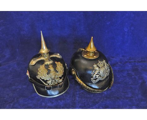 A Bavarian N.C.O pickelhaube with brass pointed finial and a similar Prussian grenadier's helmet with white metal spike. 