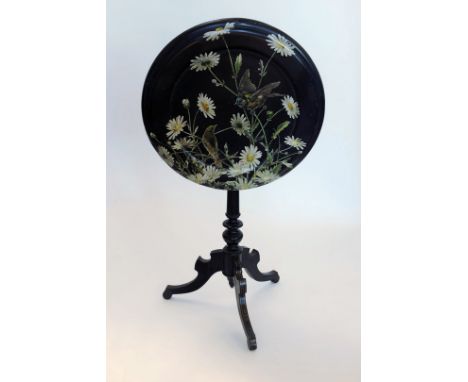 A 20th century black painted tilt topped table, the table top with transfer decoration of song birds and flower heads on a tu