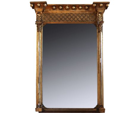 A 19th century gilt framed wall mirror with orb finial and Corinthian columns flanking the mirror plate. 27½ins wide. 