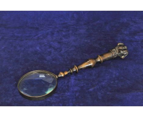 A bronze magnifying glass with bull-dog form finial (glass af). 13ins. 
