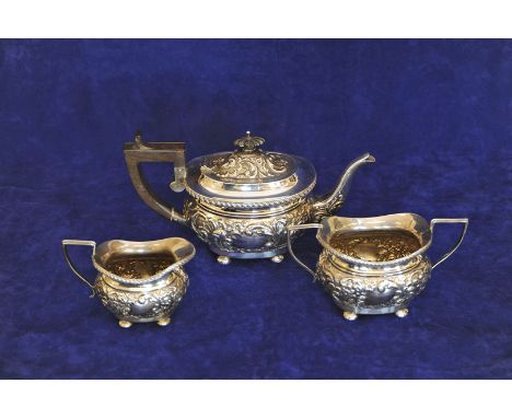 A late Edward VII/early George V silver three piece tea set comprising teapot with ebony finial and angular handle with all-o