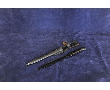 A World War II German bayonet, the 10ins blued blade stamped Jos Corts. The reverse numbered 5595, together with its scabbard