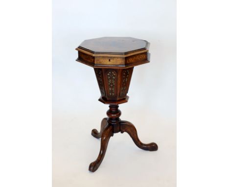 A Victorian octagonal sewing table with floral marquetry inlay to the octagonal lid, opening to reveal a compartmented interi