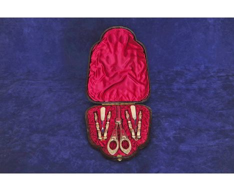A pair of plated grape scissors with shell and gadroon cast handles, two pairs of nut crackers with stylised flower head deco