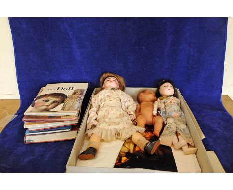 A bisque headed doll, the reverse of the neck stamped 'F.G.', two other dolls and a quantity of books on dolls and dolls hous