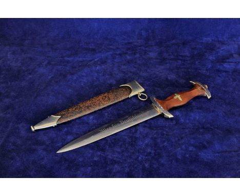 A German Second World War Sturmabteilung (SA) dagger with brown wooden handle inset with SA and Nazis eagle and swastika, the