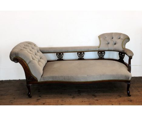 A Victorian mahogany chaise longue with button back and pierced scroll carved supports and serpentine front seat, on cabriole