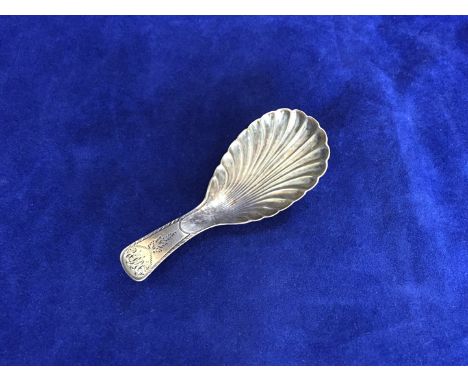 A George III silver caddy spoon with shell pattern bowl, the handle with initials RJH. Birmingham 1806. Maker JW. 