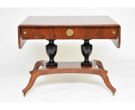 A Regency style parcel ebonised mahogany sofa table, 19th centuryThe boxwood strung top with drop leaves above a strung friez