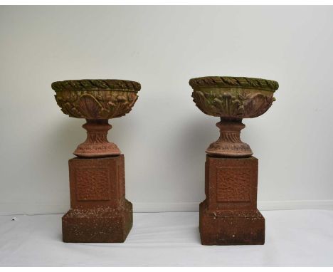 A pair of buff terracotta garden urnsFirst half 20th century, the rims moulded with acanthus leaves above relief moulded flow