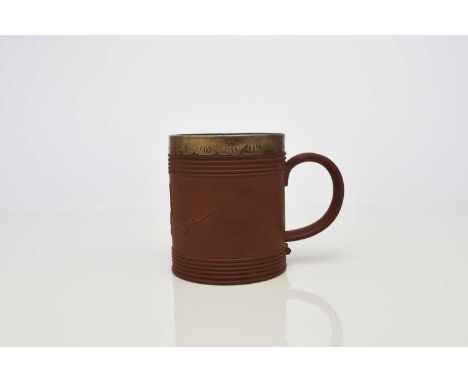 An Elers type red stoneware mug, probably early 18th century, of cylindrical form, with engine-turned banded borders and prun