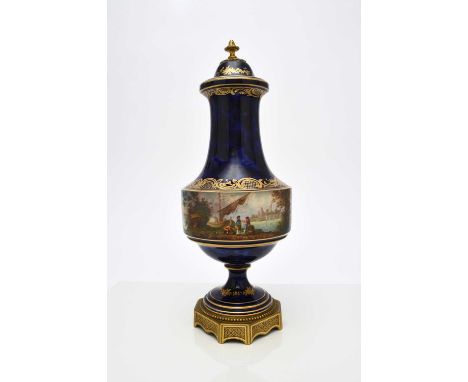 A Sevres style vase and cover, late 19th centurycobalt ground with a central band painted all around with a river scene of fi