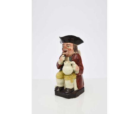 A Wood family toby jug, circa 1790-1800, of 'Mould 51' type (raised glass), the unusually bearded fellow with ruddy cheeks an