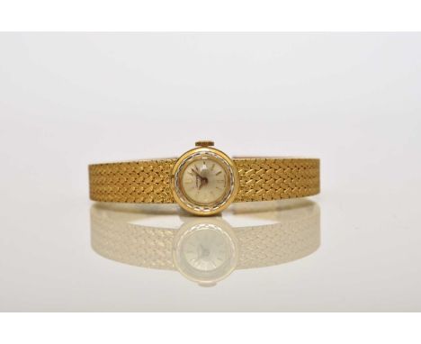 Longines: A lady's 18ct gold bracelet watchDate: Circa 1968Movement: Cal.320, 17-jewel, manualDial: Brushed champagne, applie