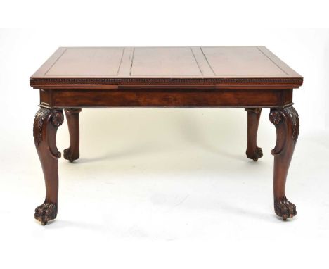 A mahogany draw-leaf dining table, early 20th century The top with guilloche moulded edge above a plain frieze with canted co