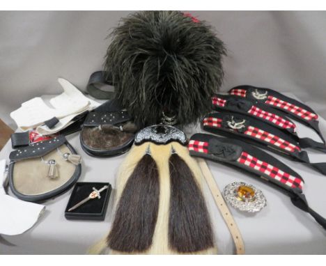 A feather bonnet together with a tray containing a new horsehair sporran, sealskin sporran, pair of white spats, belts, ties,