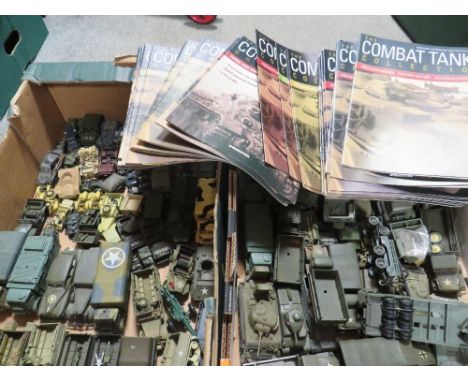 Two trays of mainly Corgi/Solido die cast military vehicles together with a box of Combat tank magazines 